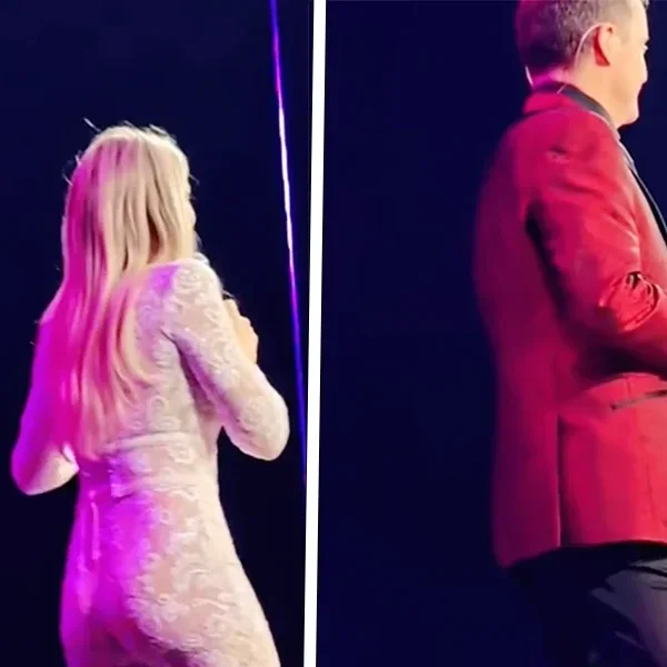 Hélène Hendriks in een loeistrak doorschijnend pakje op het podium