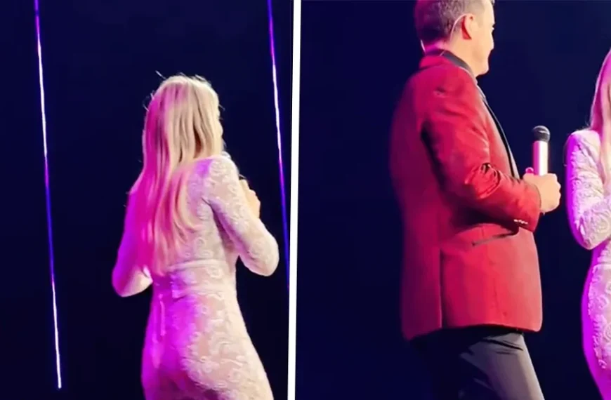 Hélène Hendriks in een loeistrak doorschijnend pakje op het podium